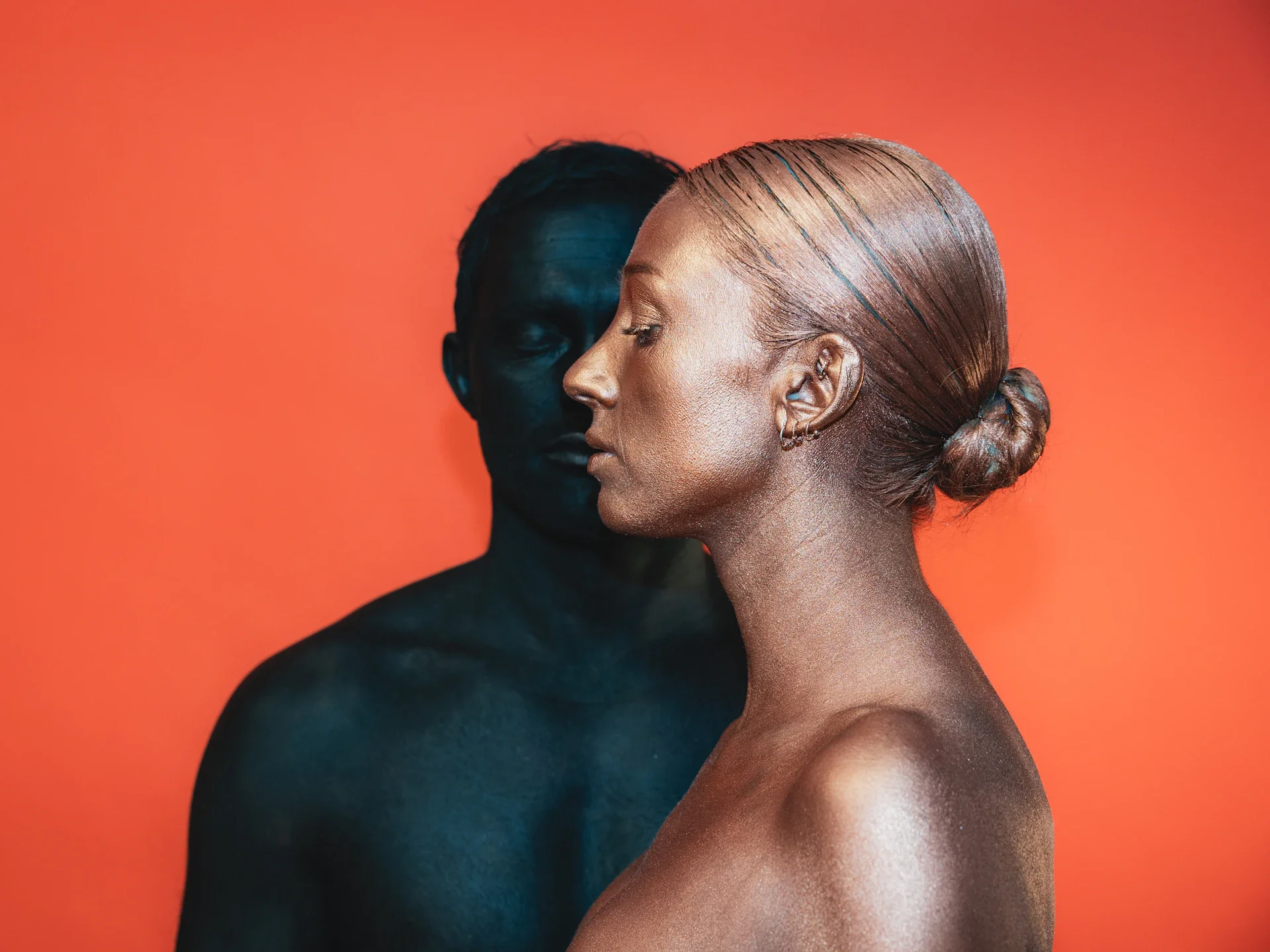 A long-exposure portrait where a figure appears to step out of its own outline, suggesting a future-self made visible alongside the present one.